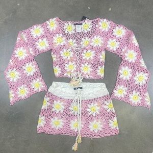 Pink crocheted top and bottom set with daisy patterns